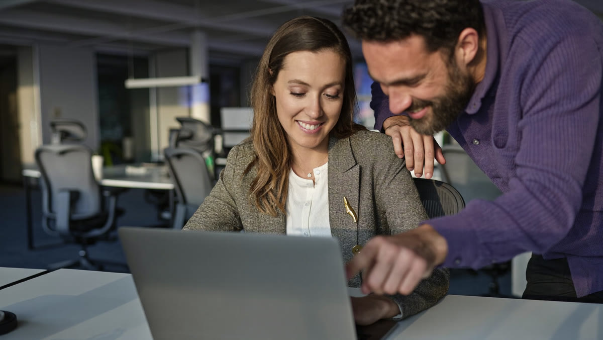 An agency owner shows a small business client what the AI agent did on a laptop