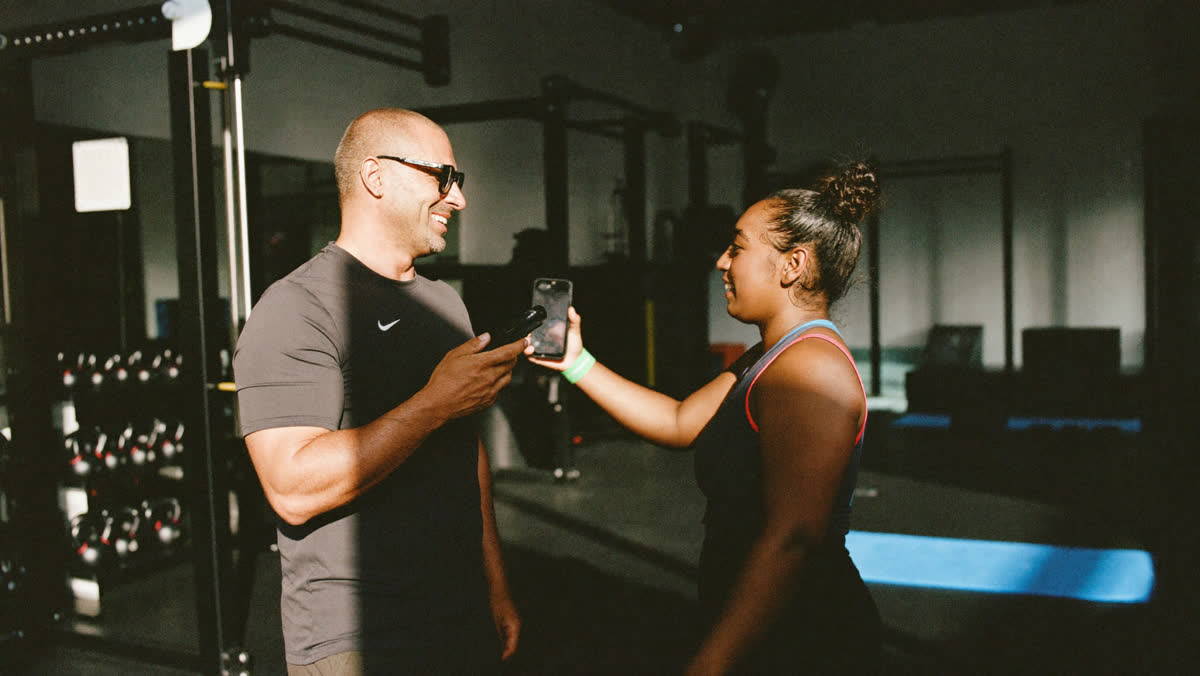 Gym owner talking with a member on the gym floor